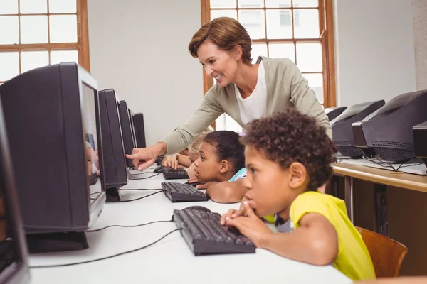 Cute pupils in computer class with teacher — Stock Photo, Image