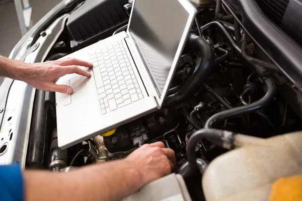 Meccanico utilizzando il computer portatile in auto — Foto Stock