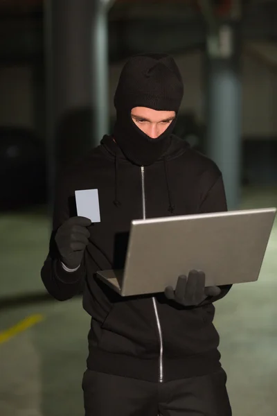 Hacker using laptop to steal identity — Stock Photo, Image