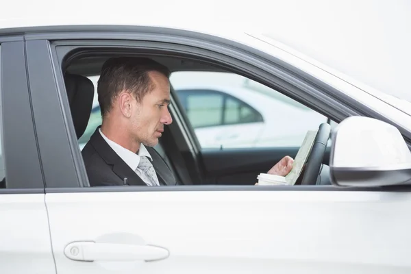 Serious businessman reading a map — Stock Photo, Image