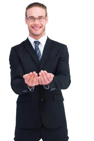 Smiling businessman holding out his hands — Stock Photo, Image