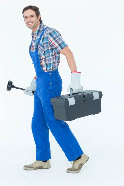 Plumber carrying plunger and tool box — Stock Photo, Image