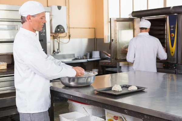 Baker making dough in mixing bowl — Stock Photo, Image