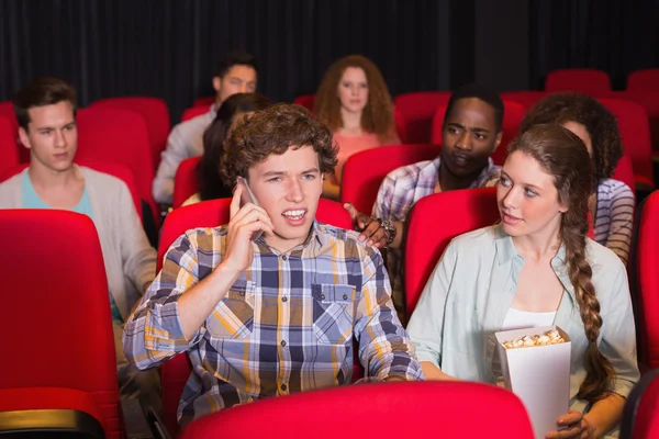 Annoying man on the phone during movie — Stock Photo, Image
