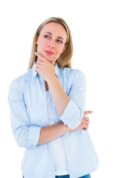 Blonde thinking with hand on chin — Stock Photo, Image