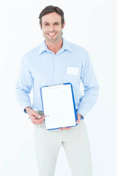 Happy businessman showing blank clipboard — Stock Photo, Image