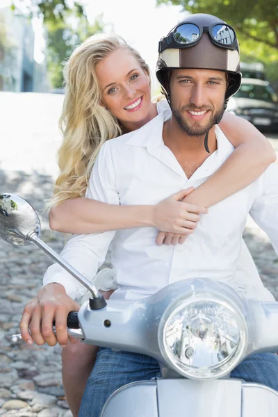 Attractive couple with their scooter — Stock Photo, Image