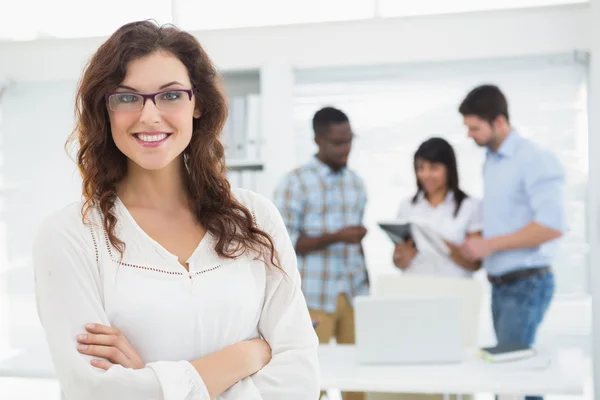 Smiling businesswoman with arms crossed — Stock Photo, Image