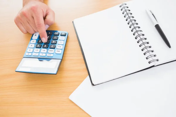 Businessman pushing key on calculator — Stock Photo, Image