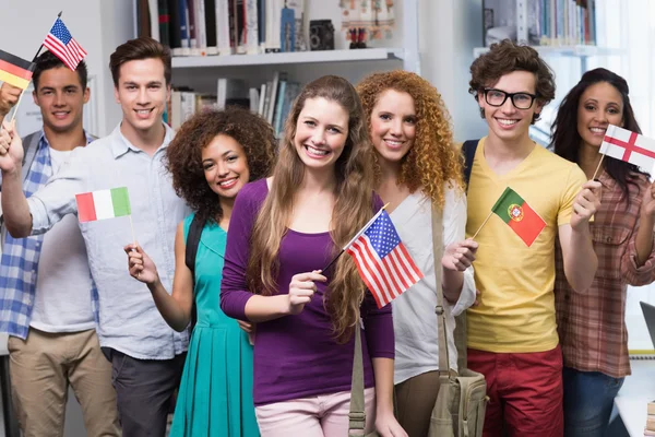 Happy students waving international flags — Stock Photo, Image
