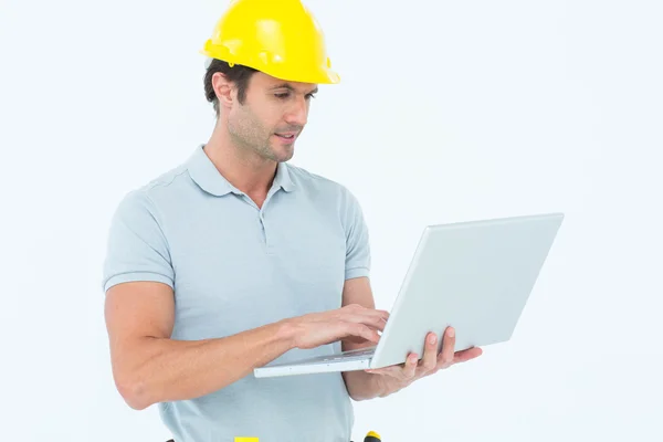 Handsome male carpenter holding laptop — Stock Photo, Image