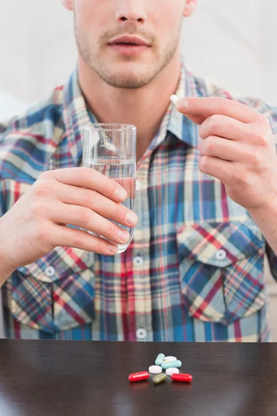 Casual man taking a tablet — Stock Photo, Image