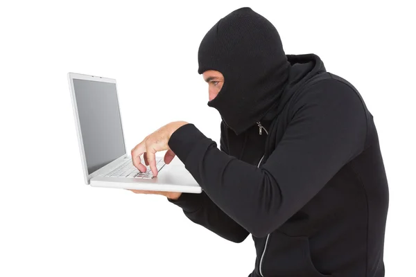 Hacker using laptop to steal identity — Stock Photo, Image