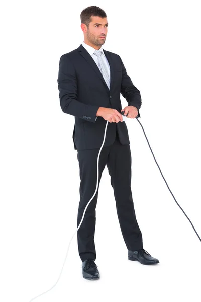 Serious businessman connecting a plug — Stock Photo, Image