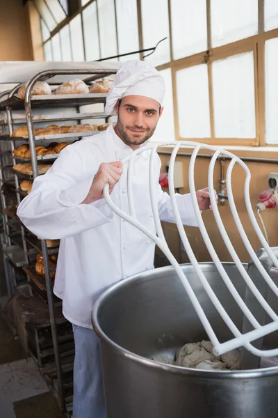 Baker preparing dough in industrial mixer — Stock Photo, Image