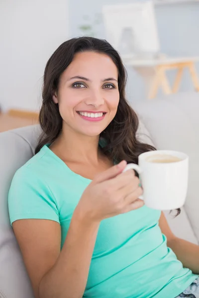 Mujer bebiendo café en el sofá — Foto de Stock