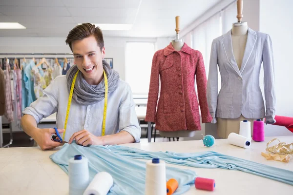 Student cutting fabric with pair of scissors — Stock Photo, Image
