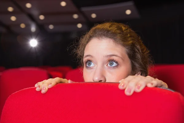 Young woman watching a scary film — Stock Photo, Image
