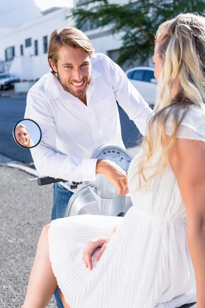 Attractive couple riding a scooter — Stock Photo, Image