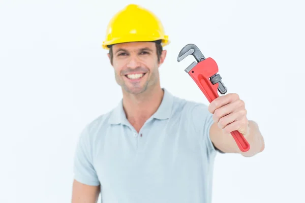 Happy carpenter holding monkey wrench — Stock Photo, Image