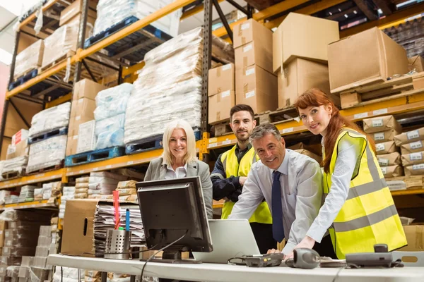 Warehouse team smiling at camera — Stock Photo, Image