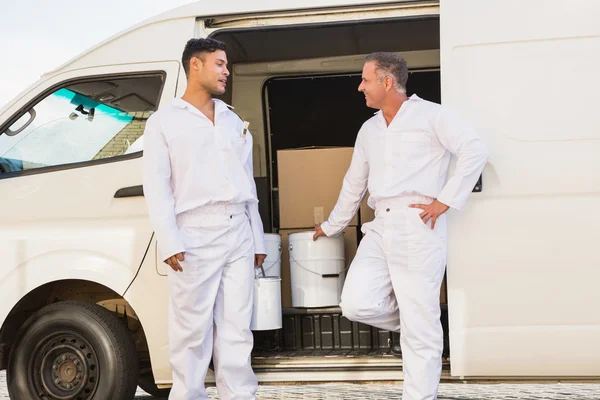 Painters smiling leaning against their van — Stock Photo, Image