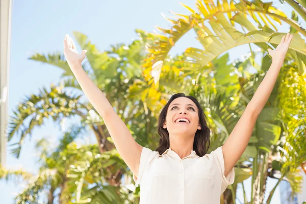 Carefree brunette with arms up — Stock Photo, Image