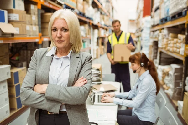 Serious warehouse manager standing arms crossed — Stock Photo, Image