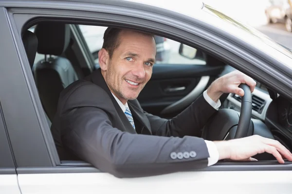 Happy businessman in the drivers seat — Stock Photo, Image