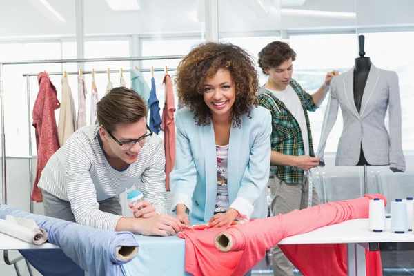 Estudiantes trabajando juntos con un tejido — Foto de Stock