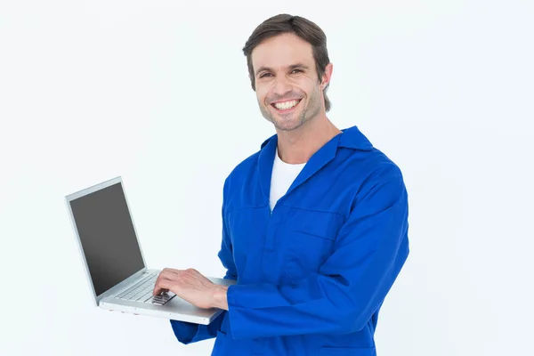 Handsome mechanic using laptop — Stock Photo, Image