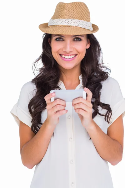 Pretty brunette holding her phone — Stock Photo, Image