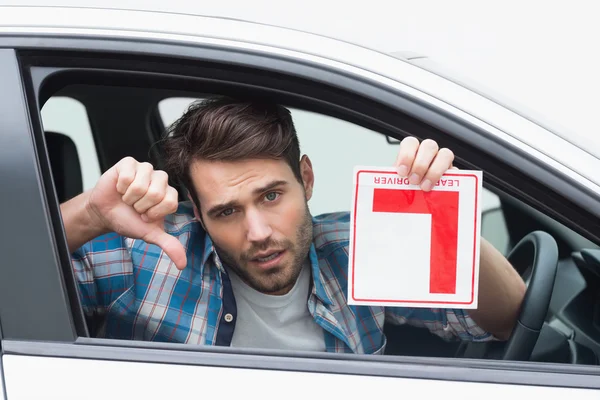 Learner driver smiling and holding l plate — Stock Photo, Image