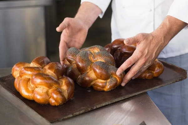 Baker checking freshly baked bread — Stock Photo, Image