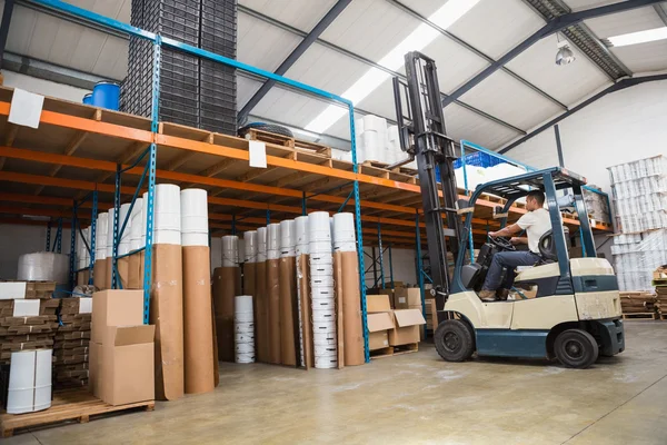 Forklift machine in large warehouse — Stock Photo, Image