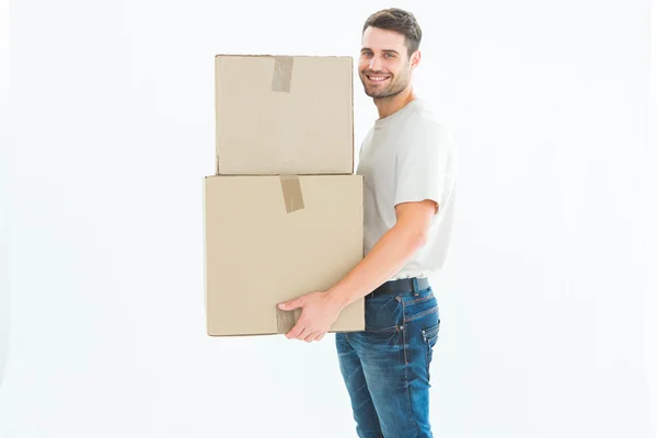 Delivery man carrying cardboard boxes — Stock Photo, Image