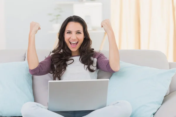 Mooie brunette juichen met laptop — Stockfoto