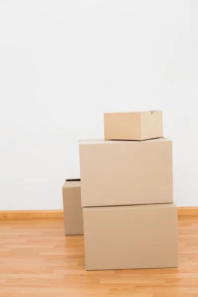 Pile of cardboard boxes on floor — Stock Photo, Image