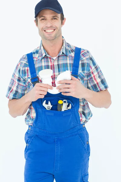 Confident plumber holding sink pipe — Stock Photo, Image