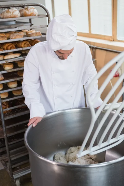 Baker preparing dough in industrial mixer — Stock Photo, Image