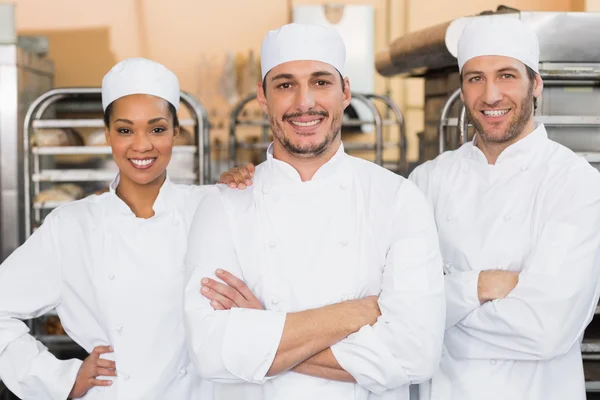 Team of bakers smiling at camera — Stock Photo, Image