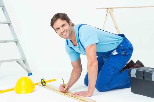 Confident worker marking on wood — Stock Photo, Image