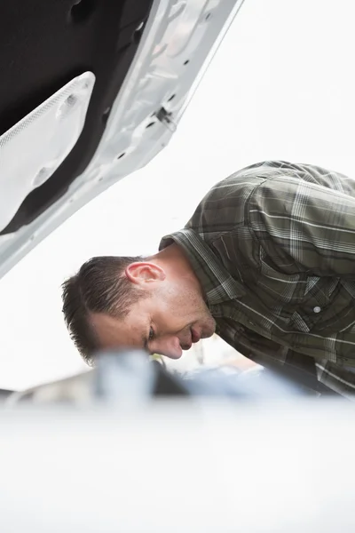 Расстроенный бизнесмен, опирающийся на свою машину — стоковое фото