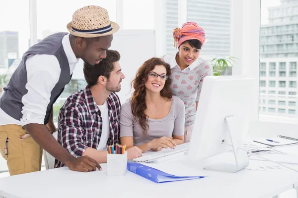 Smiling coworkers using computer monitor — Stock Photo, Image