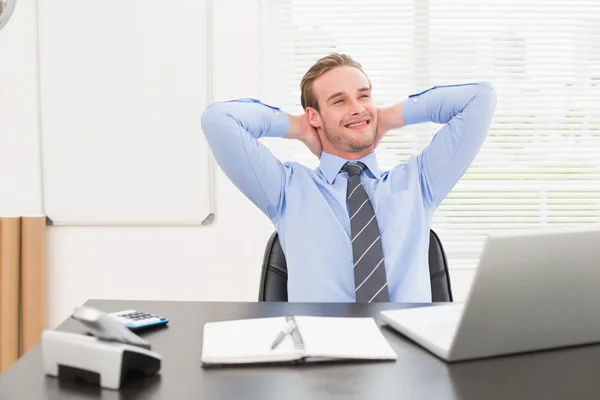 Relaxing businessman at his desk — Stock Photo, Image
