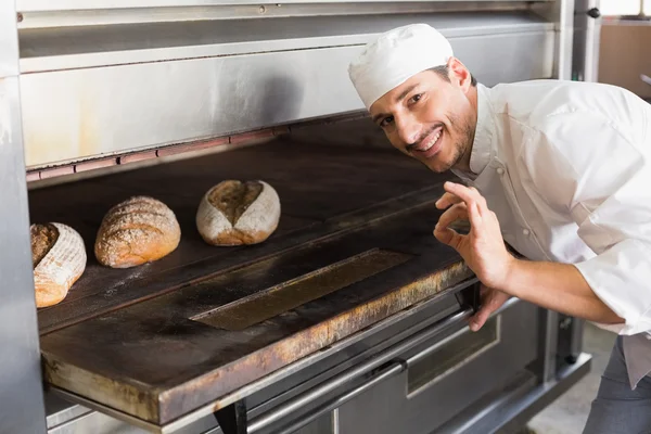 Happy baker by open oven — Stock Photo, Image