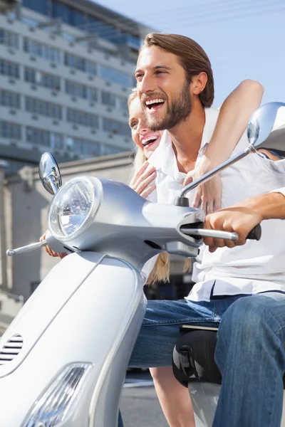 Cute couple riding a scooter — Stock Photo, Image