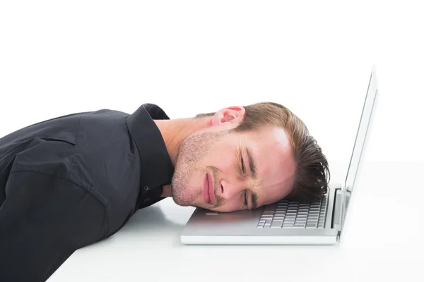 Tired businessman resting on laptop — Stock Photo, Image