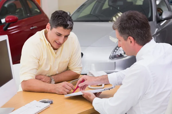 Salesman showing client where to sign deal — Stock Photo, Image