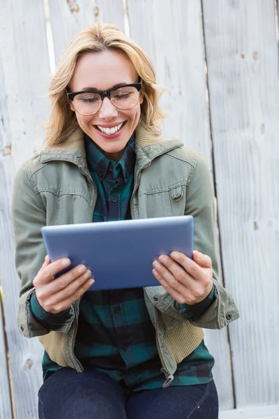 Happy blonde using tablet pc — Stock Photo, Image